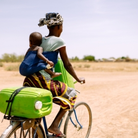 Woman and child on bicycle in Western Uganda