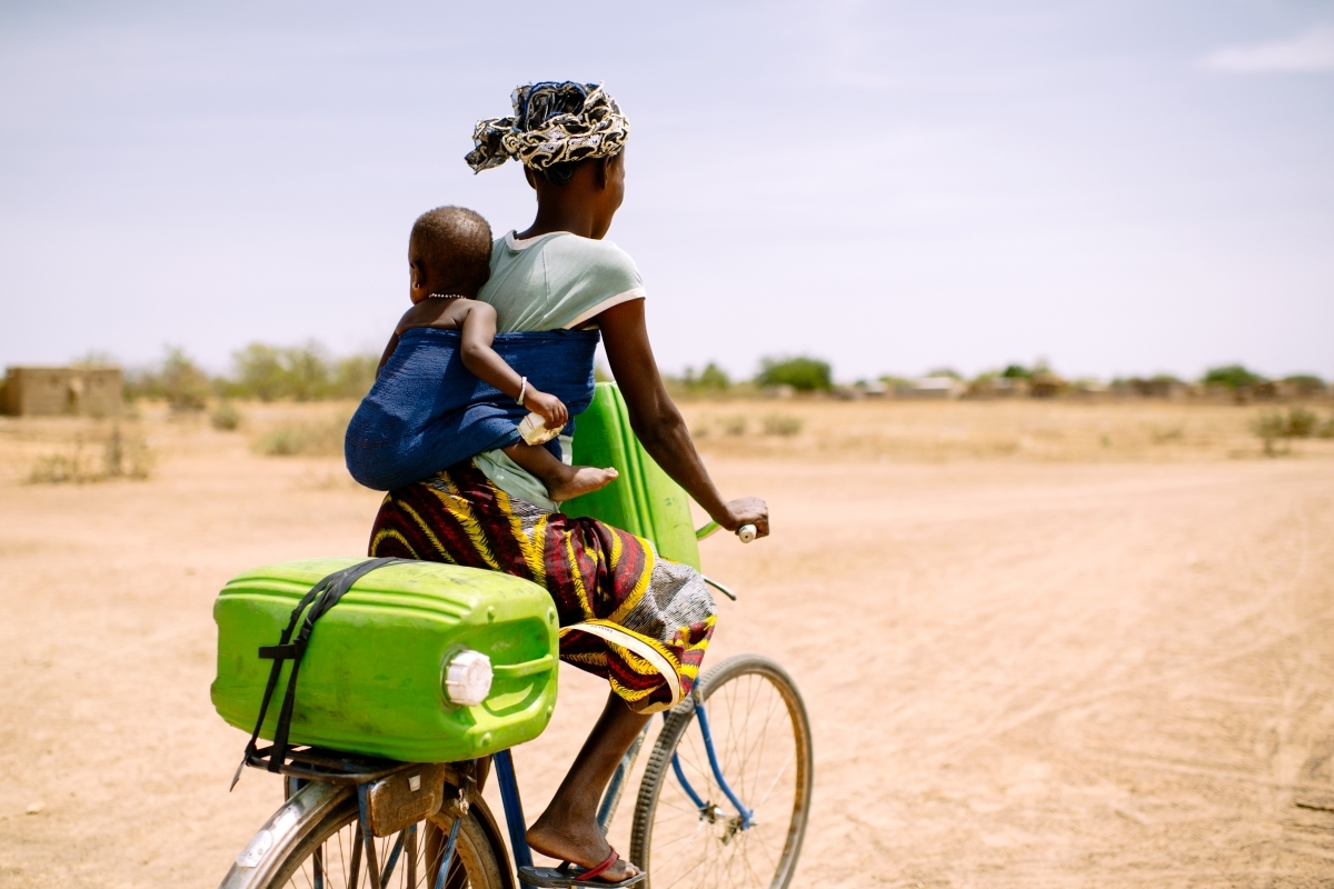 Woman and child on bicycle in Western Uganda
